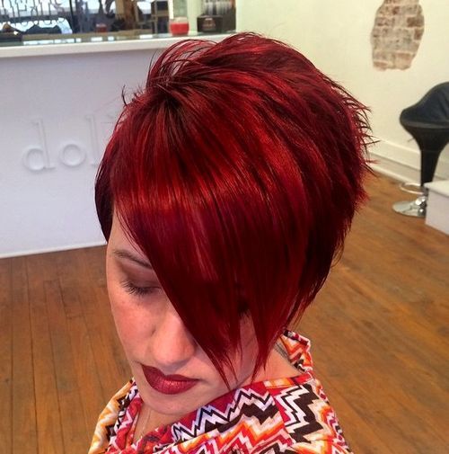 kort asymmetrical red haircut with long bangs