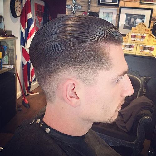sleeked back long top tapered sides hairstyle