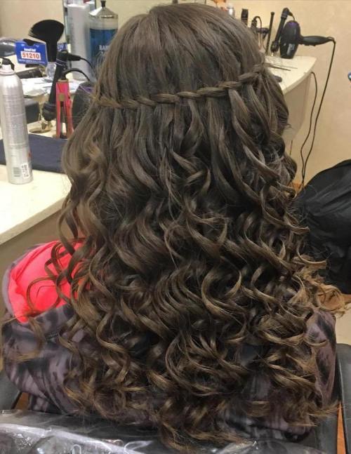 dlho curly hairstyle with a thin waterfall braid
