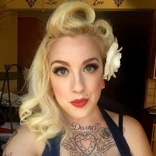 blond asymmetrical victory rolls hairstyle