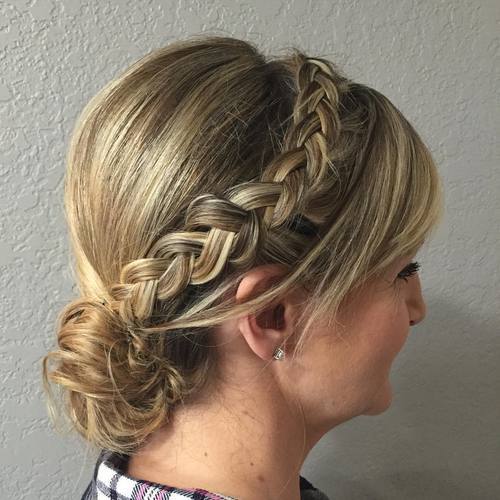 stran braid and low bun updo with bangs for women over 40