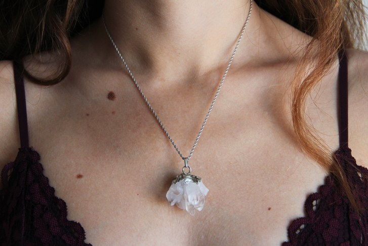 A închide shot of woman wearing crystal necklace